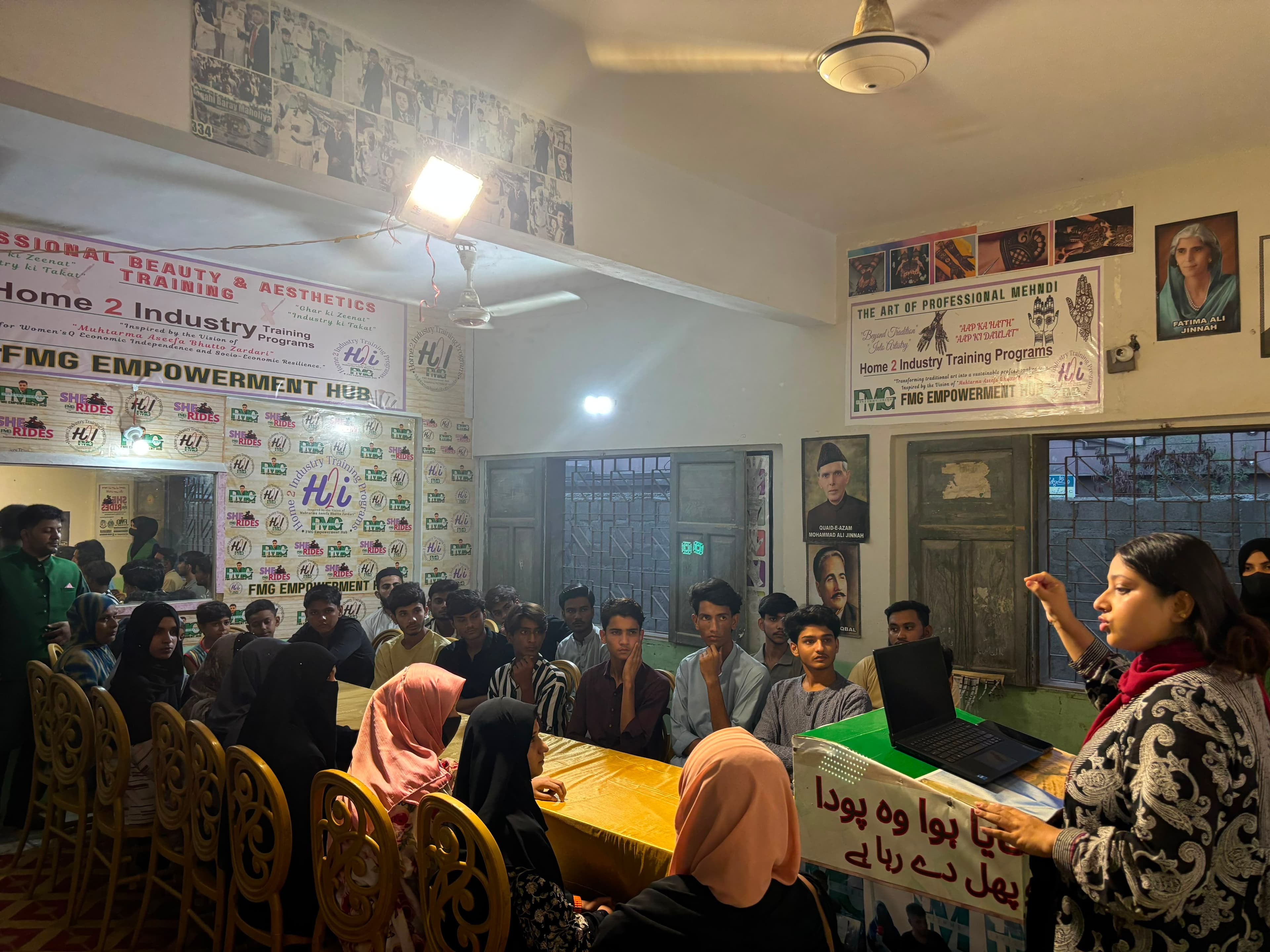 Young people listening to a community green energy presentation in Karachi.